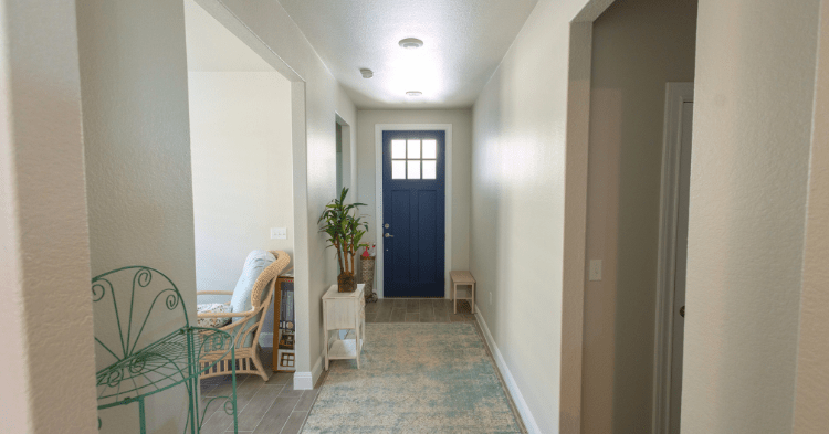 A shot from the other end of a entryway hallway with a blue painted door at the end of it_That 1 Painter Arlington-Alexandria