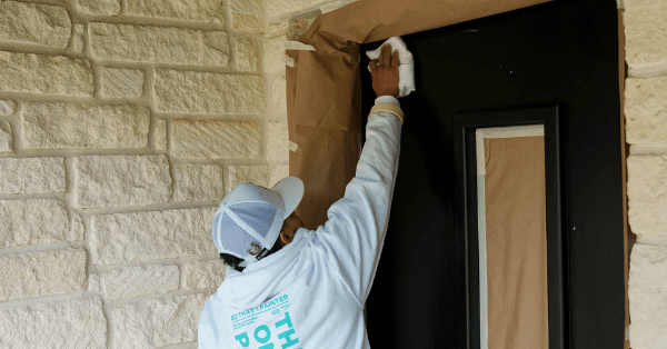 Professional painter adding finishing touches to a freshly painted front door_That 1 Painter Arlington Alexandria