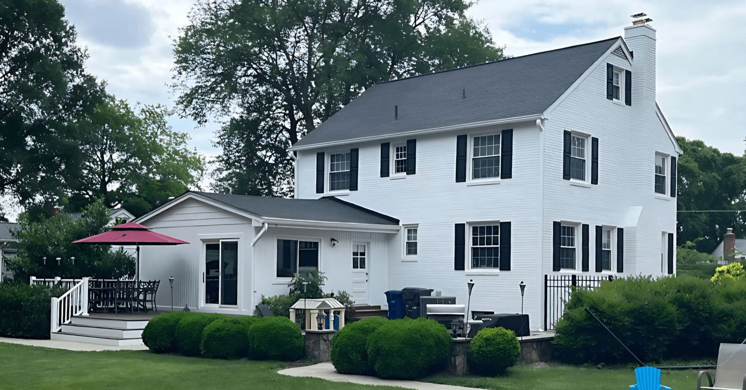 Two story brick home painted white by professional painters in Arlington Alexandria at That 1 Painter.
