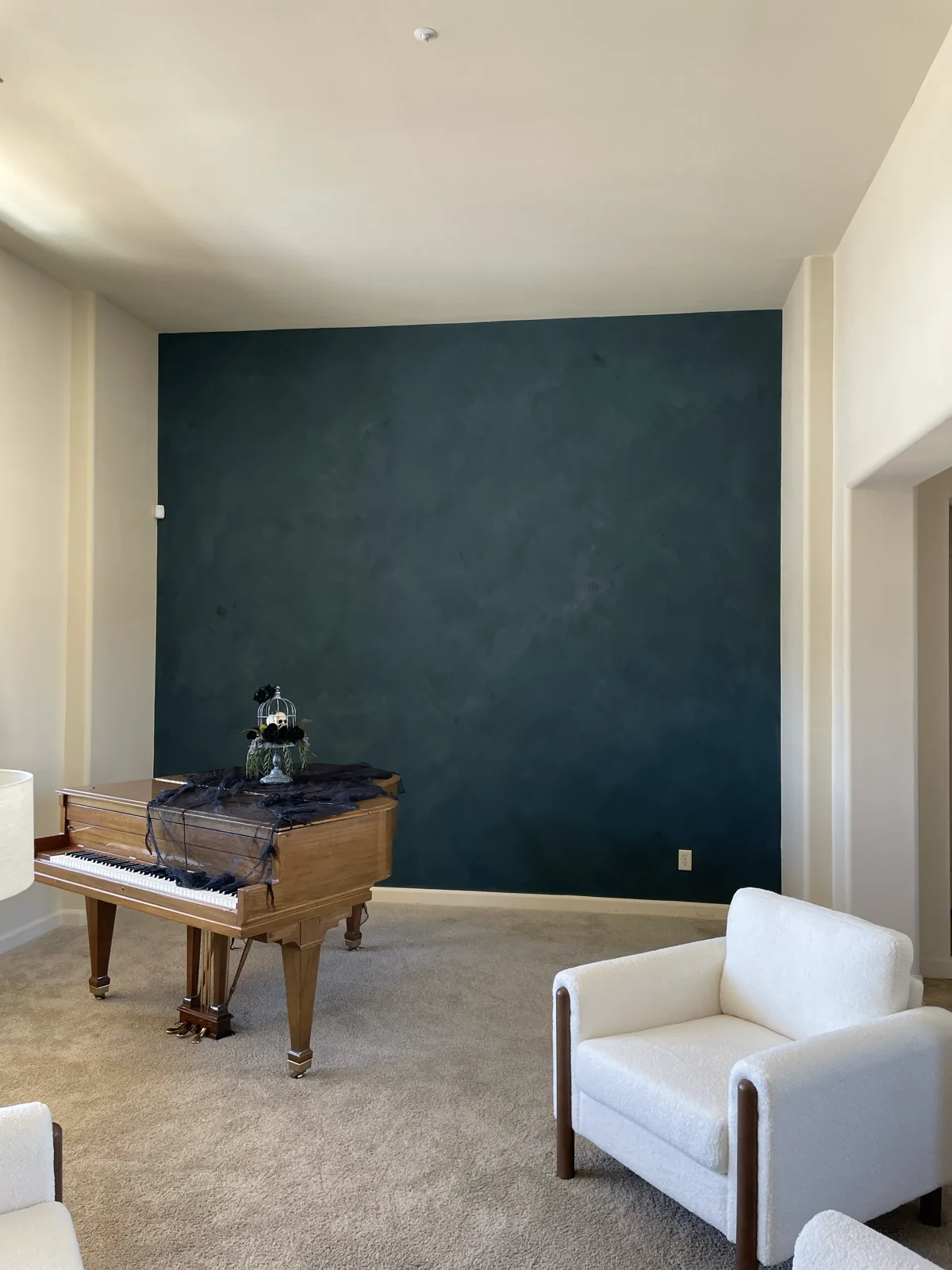 Deep teal limewash accent wall with soft mottled movement in a vaulted formal living room applied by That 1 Painter Chandler-Gilbert
