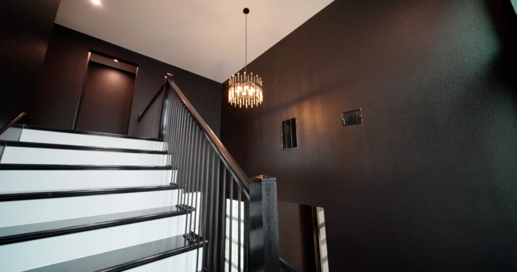Luxury black high-ceiling stair wall painted by a professional painter in St. Paul, MN