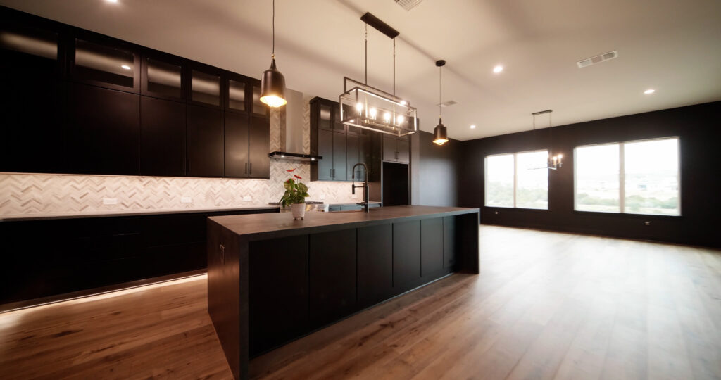 Modern luxury kitchen featuring black painted walls and spray-painted black cabinets by a professional painter in St. Louis Park, MN