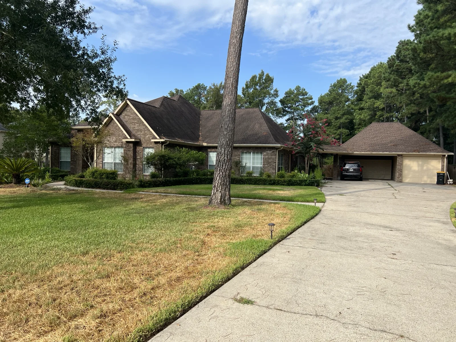 Orange-red brick home exterior before limewash, with dark roof and front lawn applied by That 1 Painter Peoria-Glendale