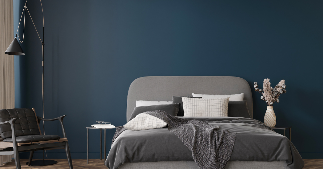 Bedroom with a deep navy accent wall in Maple Grove, MN