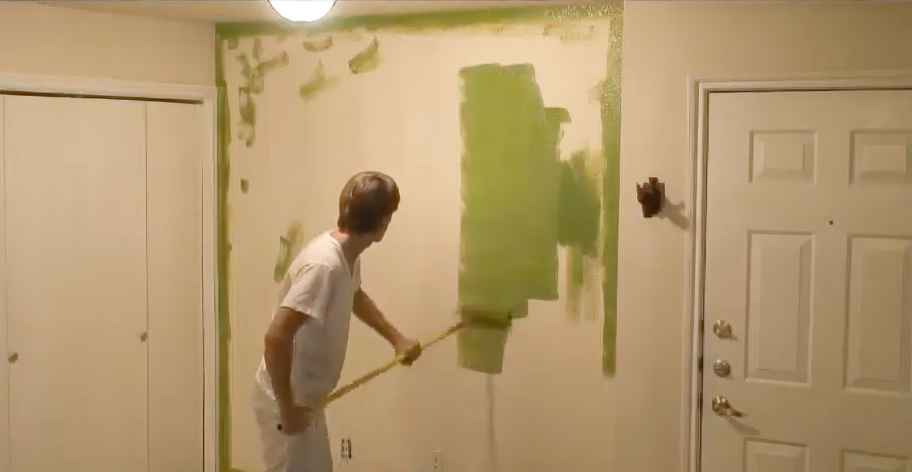 A That 1 Painter painter rolling fresh color onto a wall in a home