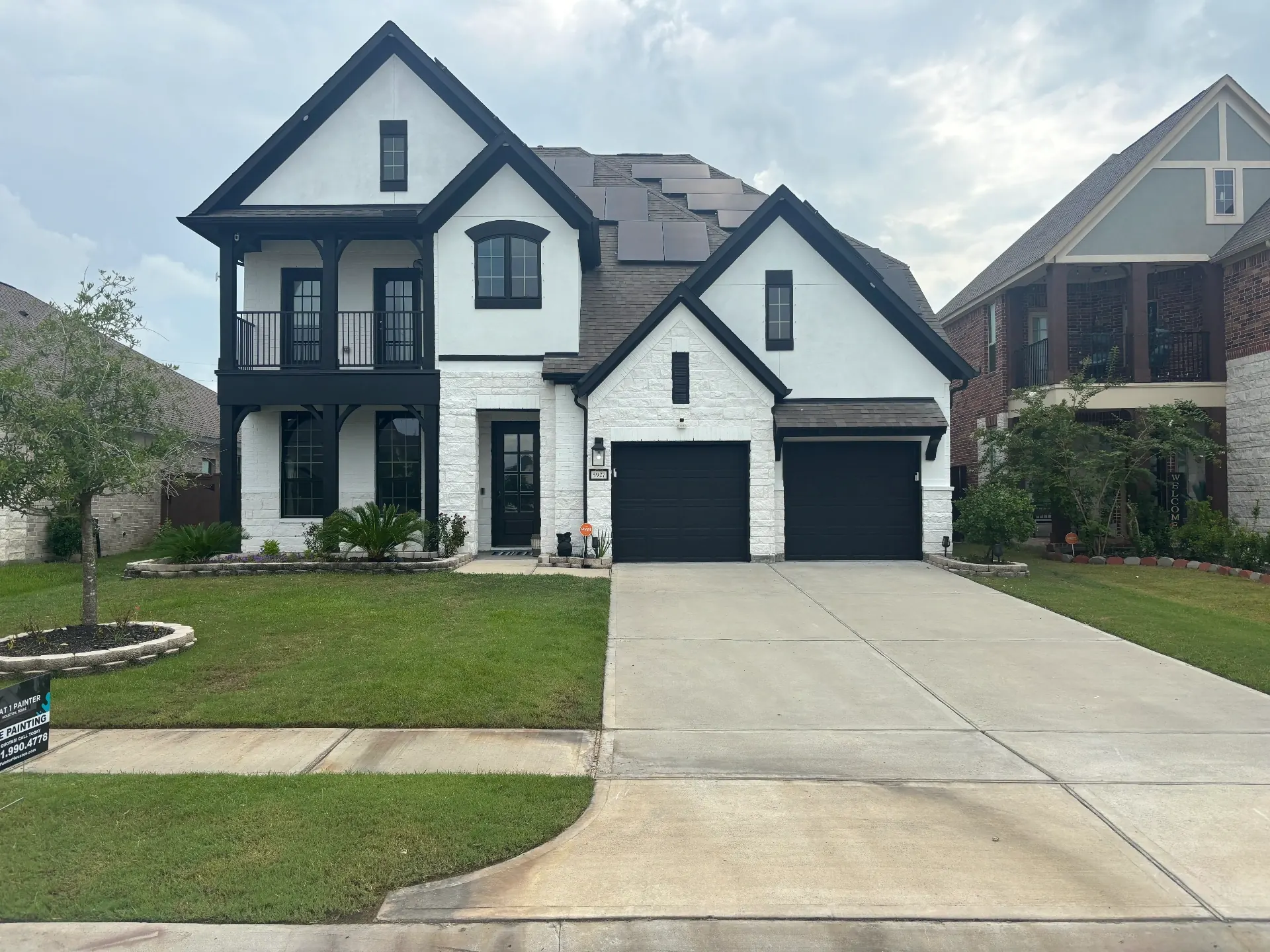 Full brick home exterior painting with dark trim accents