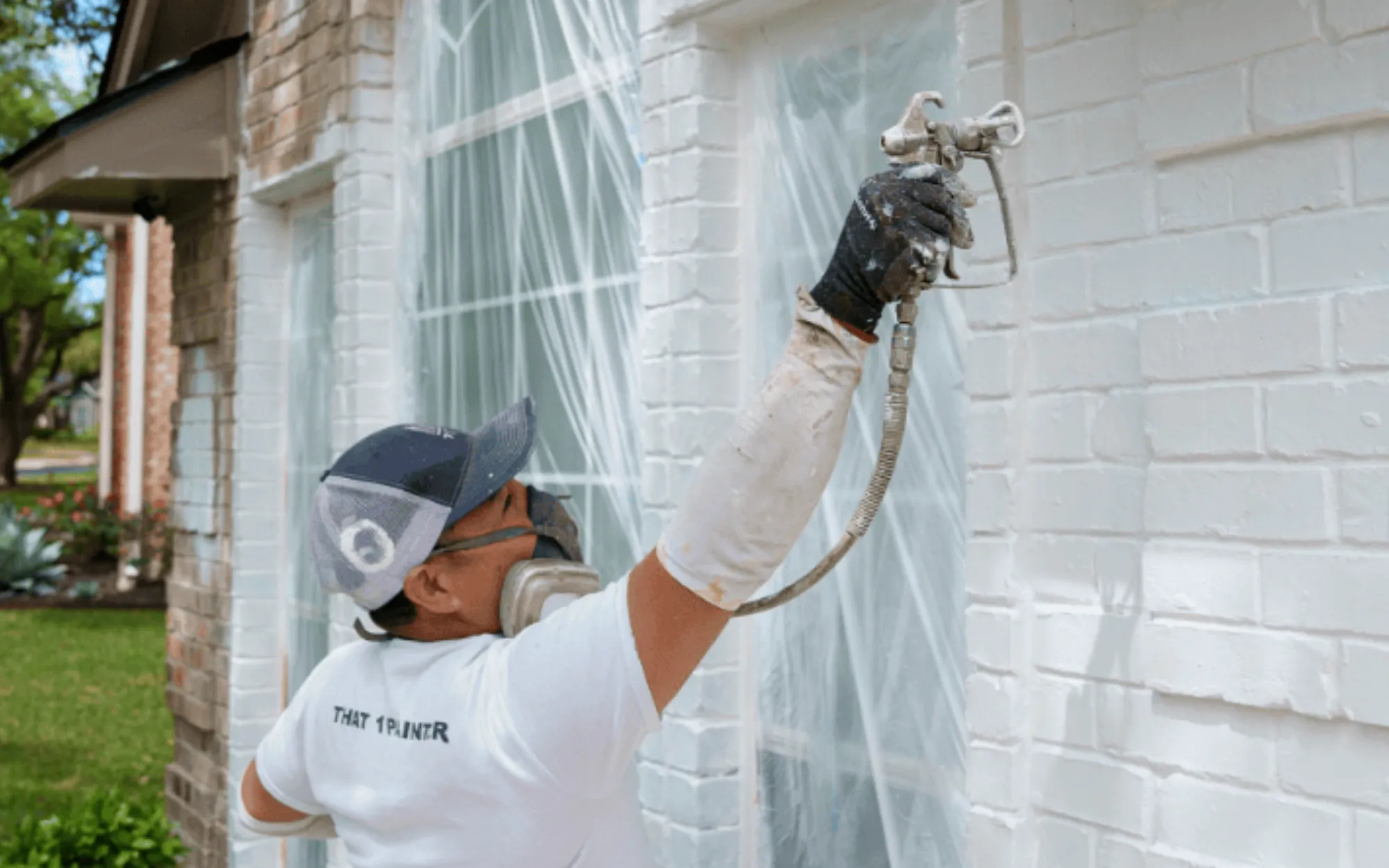Brick home masking and spray painting process in Bellaire, TX