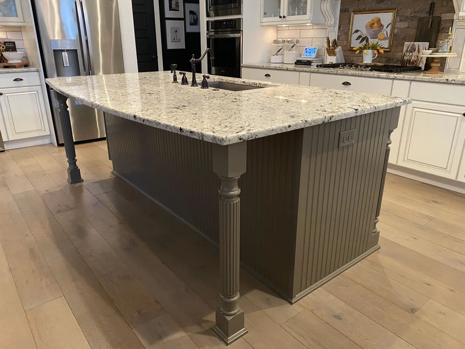 Eagle kitchen island refinished in warm grey with fluted detail and granite counter by That 1 Painter Treasure Valley
