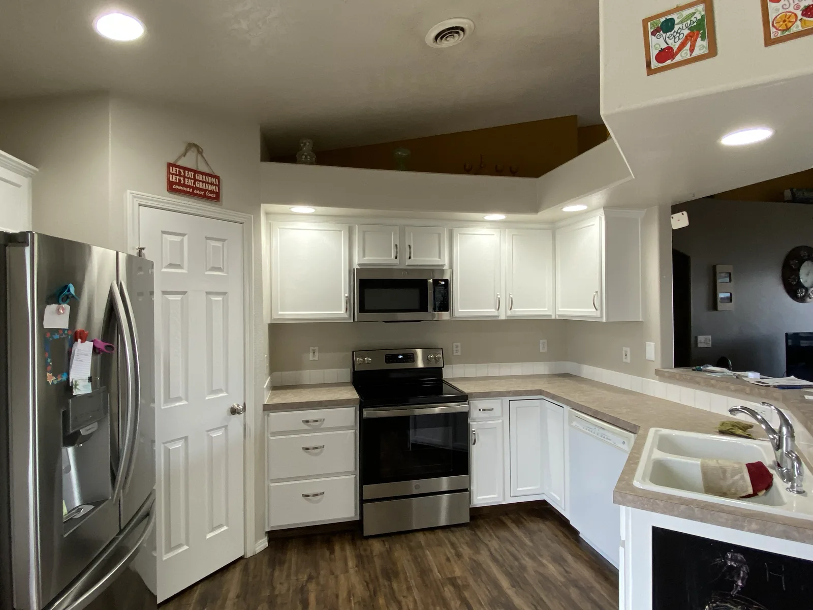Caldwell kitchen cabinets refinished in white with stainless appliances by That 1 Painter Treasure Valley