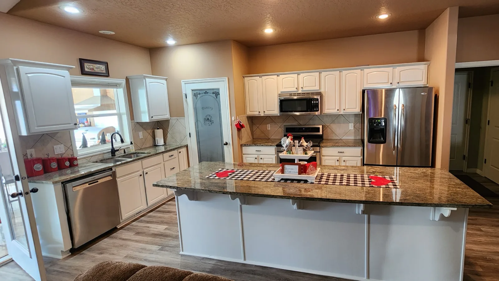 Caldwell kitchen refinished in cream with a granite island by That 1 Painter Treasure Valley