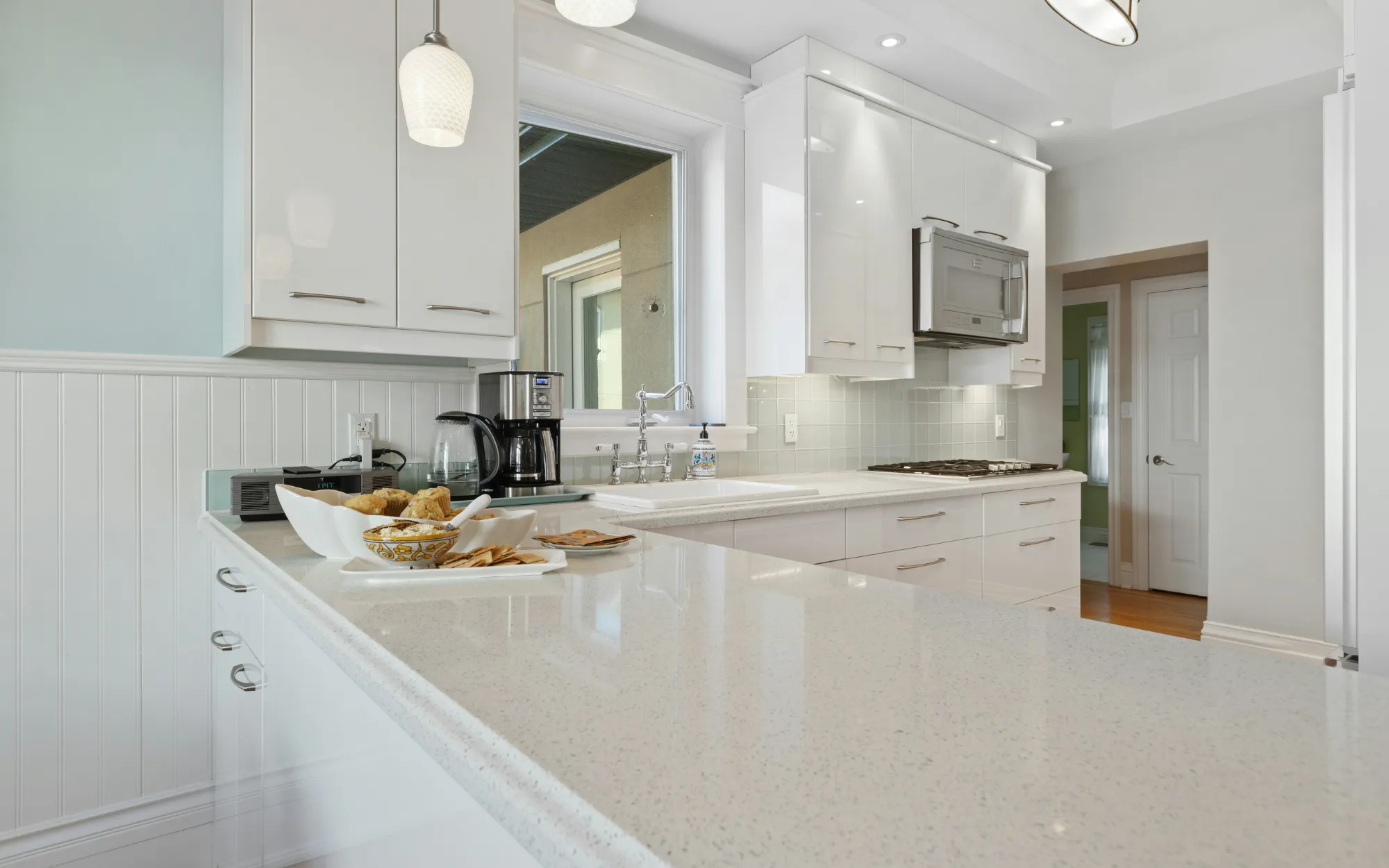 Bright white painted kitchen cabinets with smooth factory-style finish