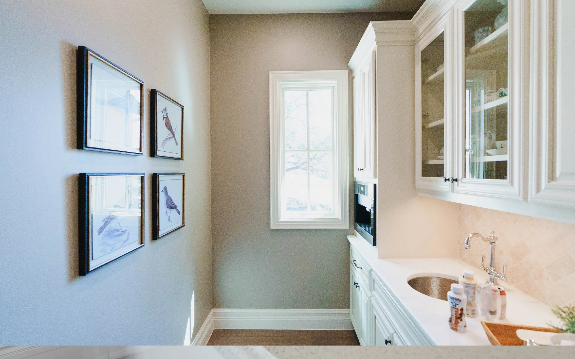 White painted butler's pantry cabinets with glass doors