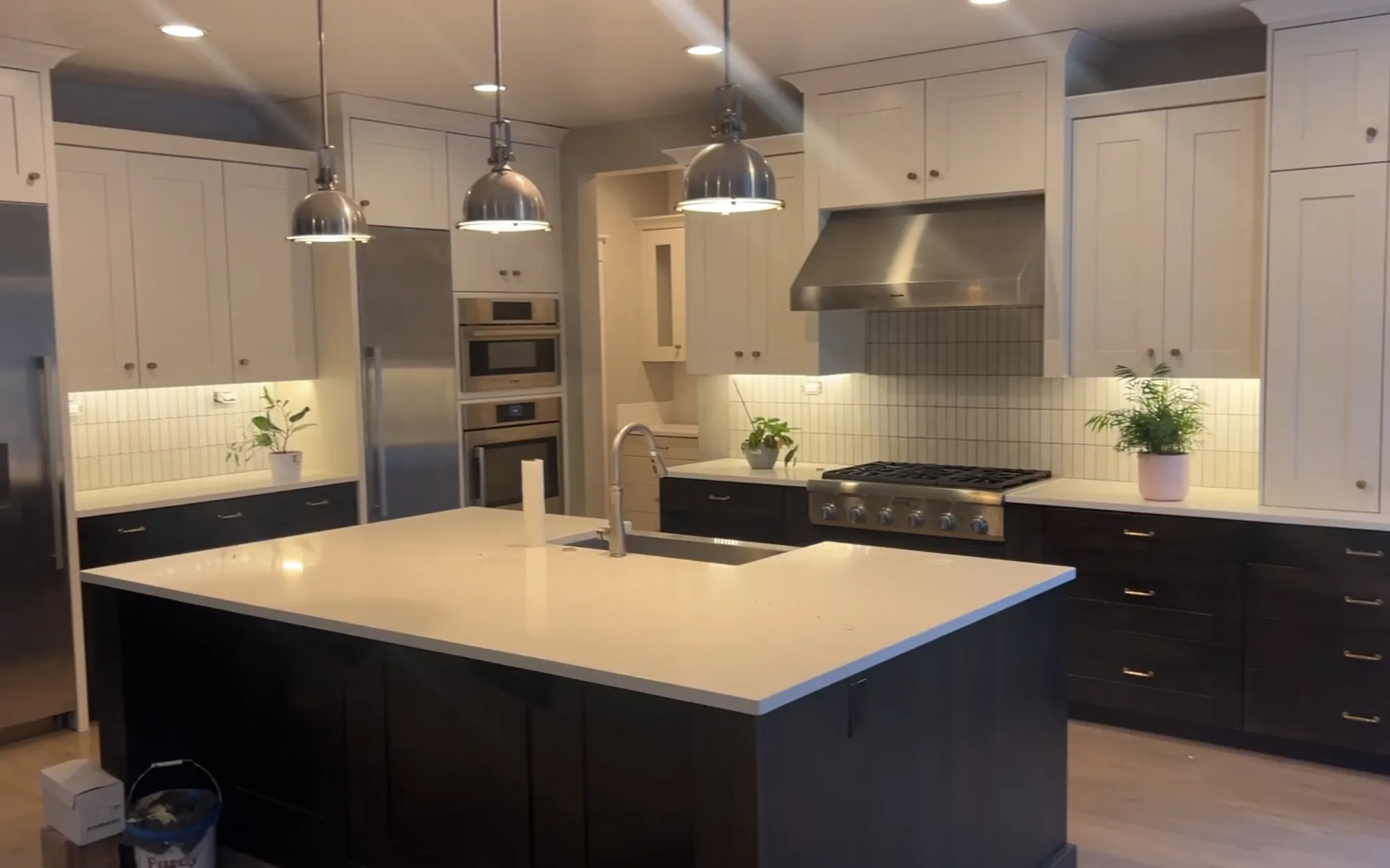 Two-tone kitchen with white upper cabinets and dark espresso lower cabinets