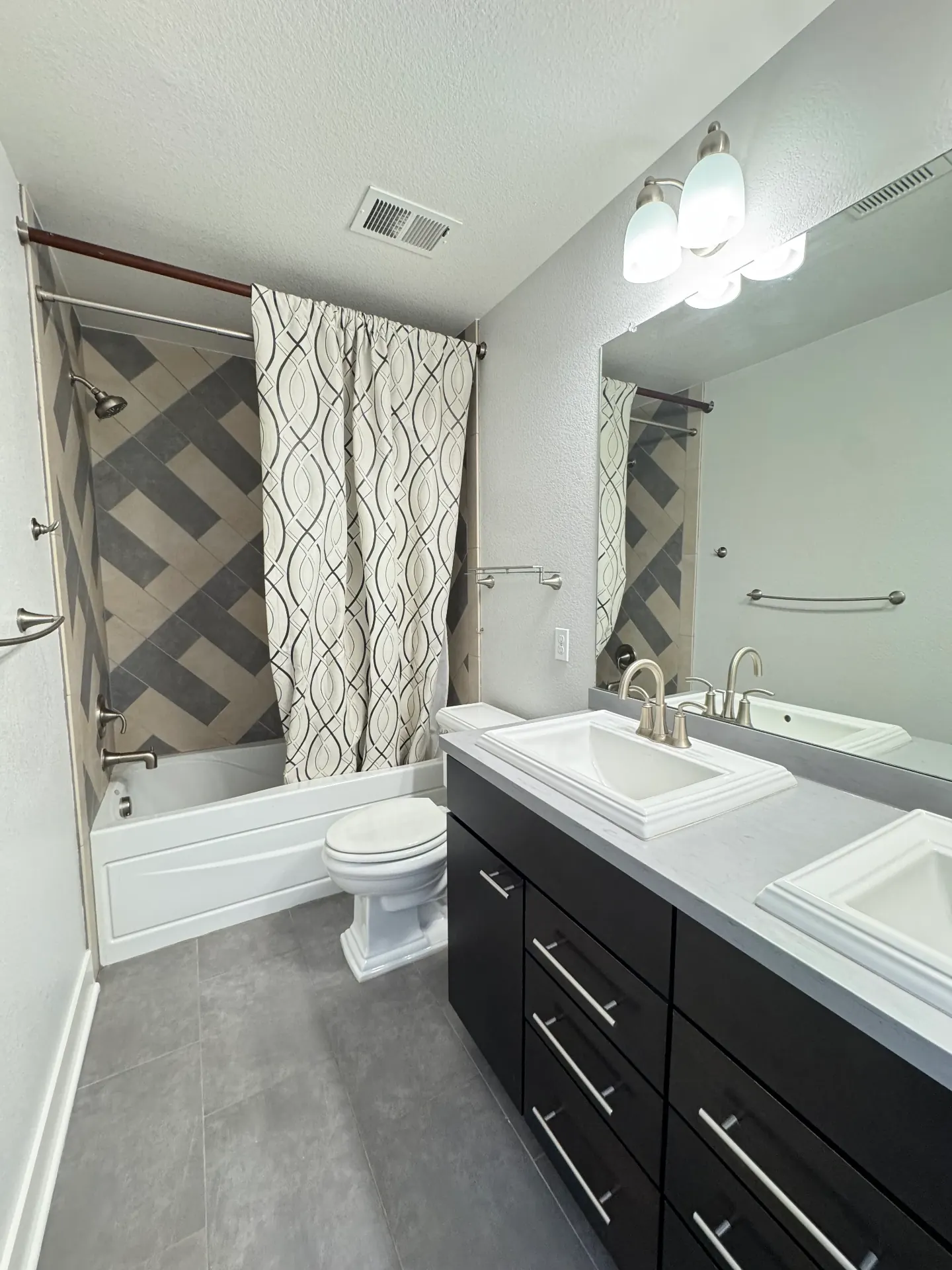 Finished bathroom with cleanly sealed tub, vanity, and trim joints after professional caulking
