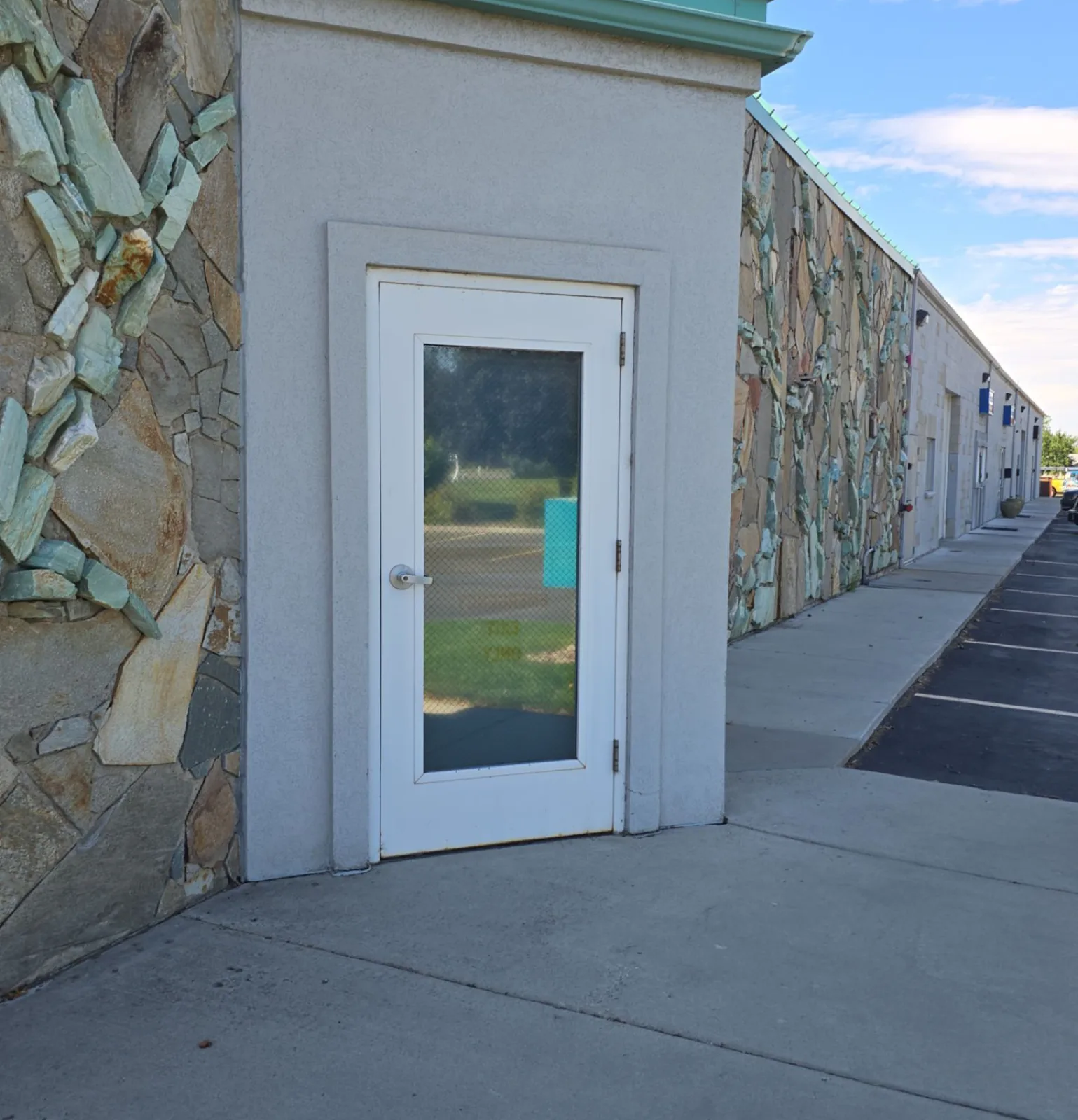 Commercial storefront entry door and stucco surround before repainting by That 1 Painter Treasure Valley