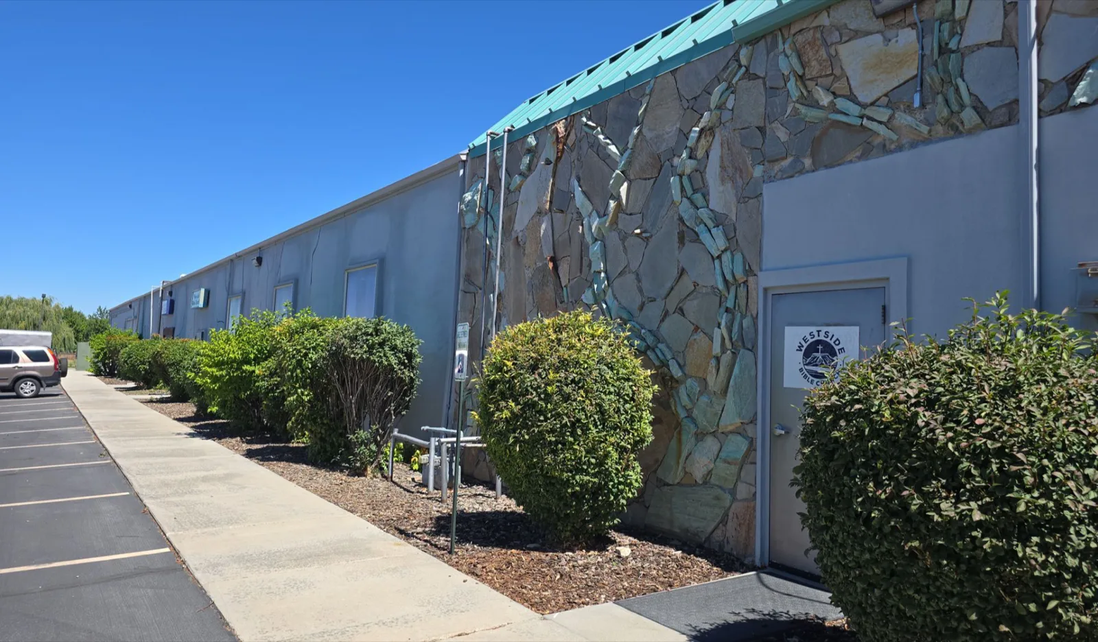 Meridian business park walkway elevation with stone facade before repainting by That 1 Painter Treasure Valley