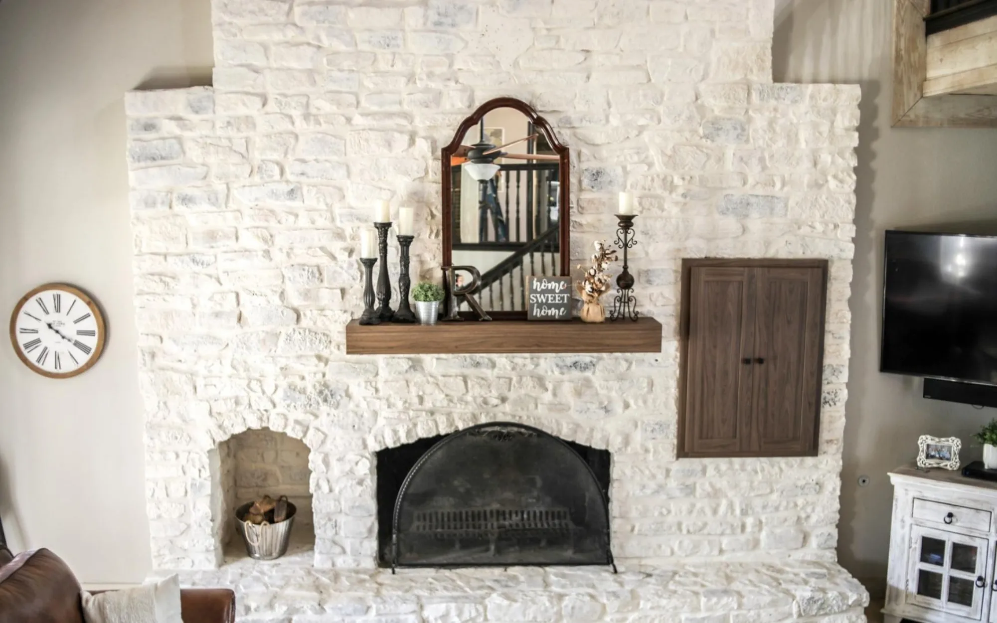 Limewash stone fireplace with rustic wood mantel