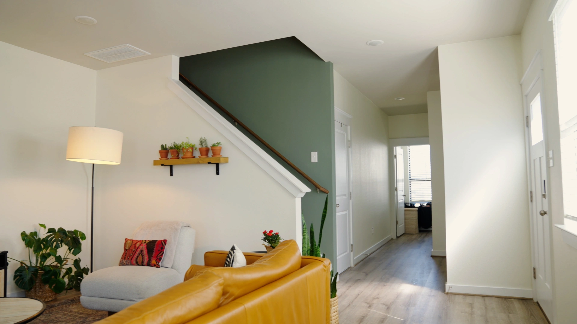 Living room accent wall painting in sage green tones