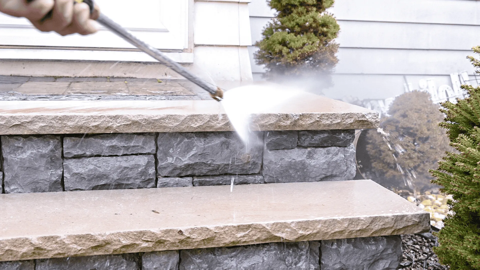Detergent being applied to siding before pressure washing