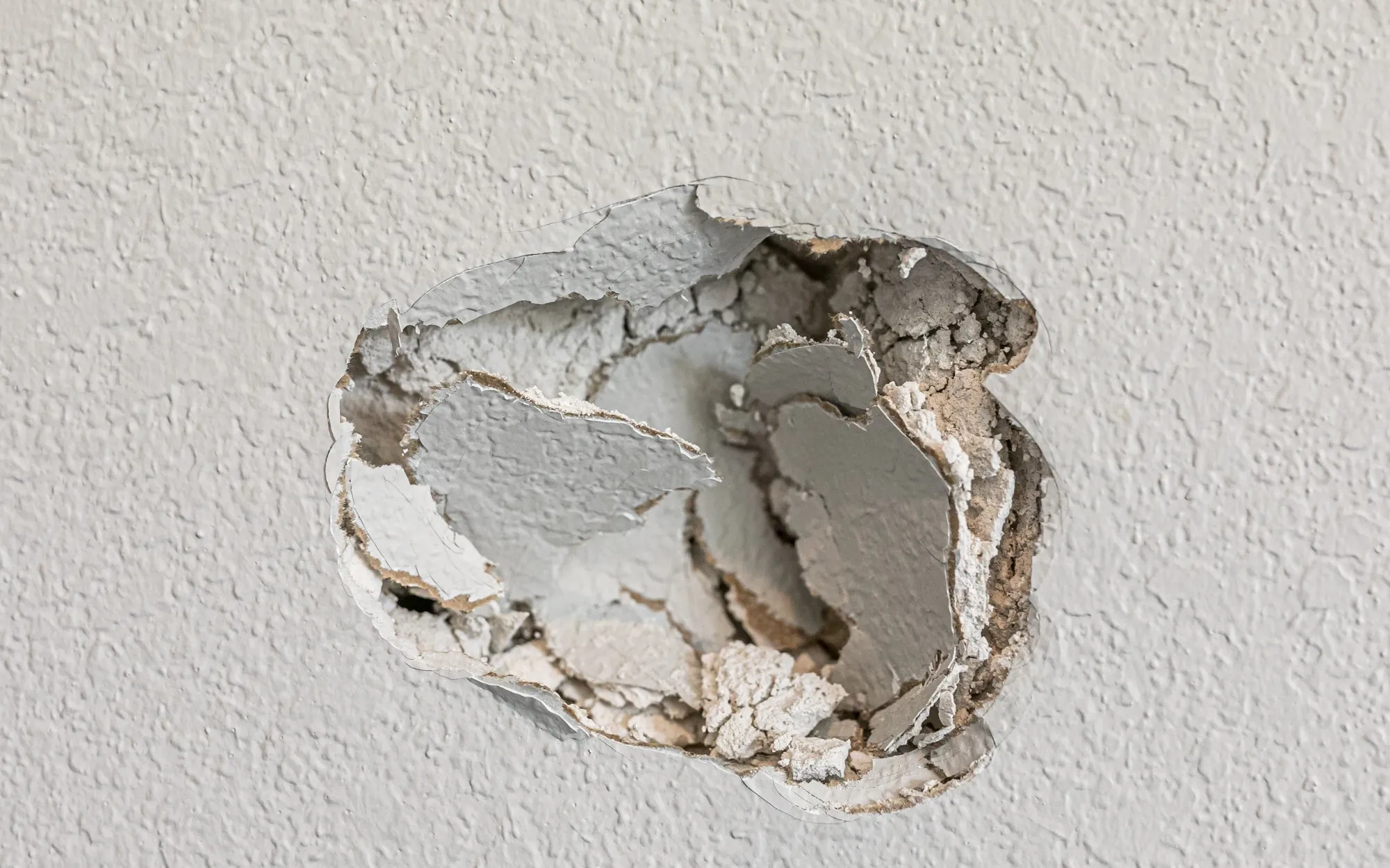 Drywall hole patching during maintenance visit