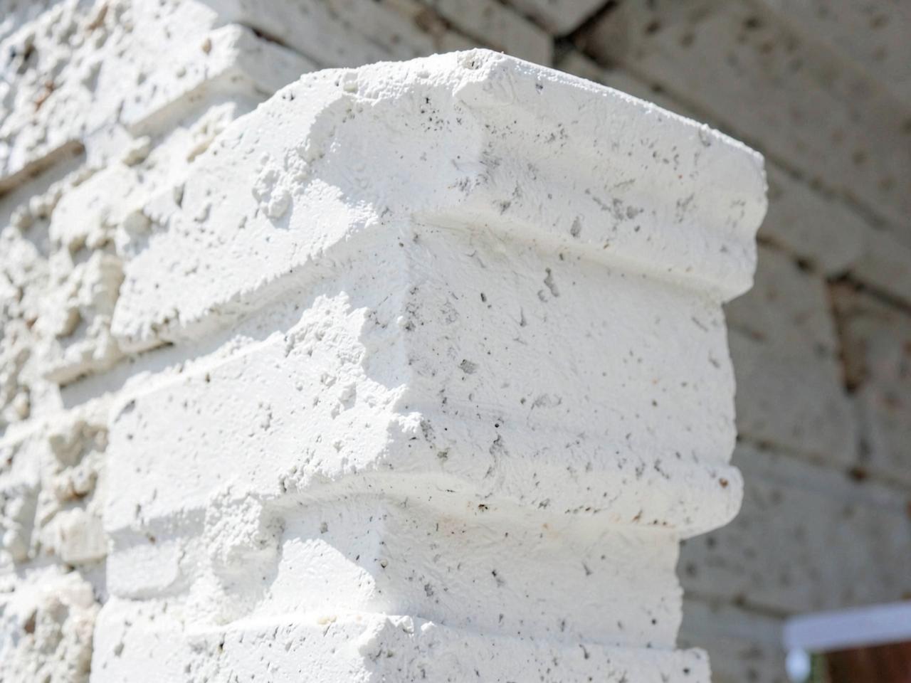 Close up of white limewash mineral finish on exterior brick