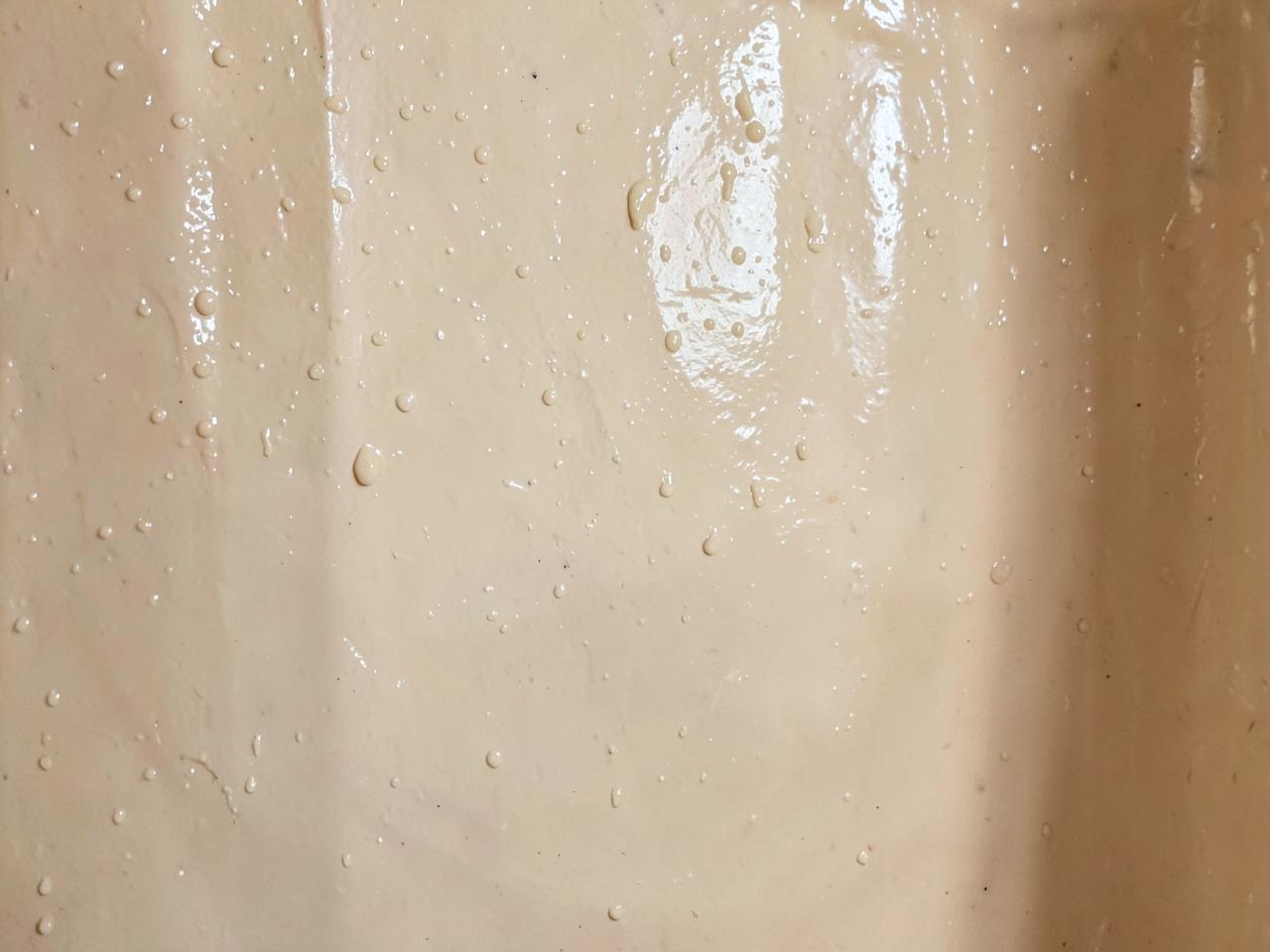 Polished Moroccan clay tadelakt shower wall beading water