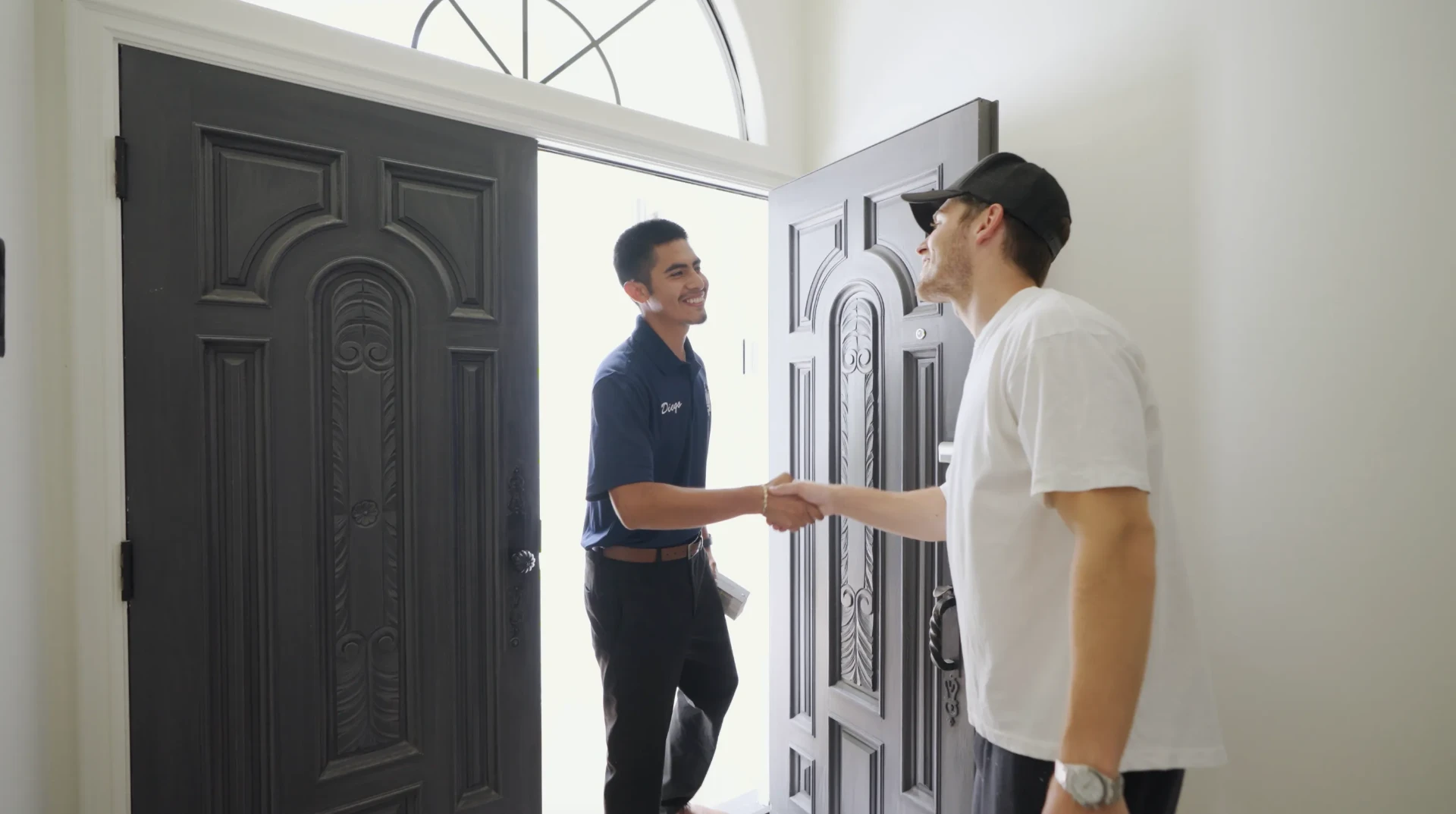 That 1 Painter project manager greeting a homeowner at the front door for a maintenance walkthrough