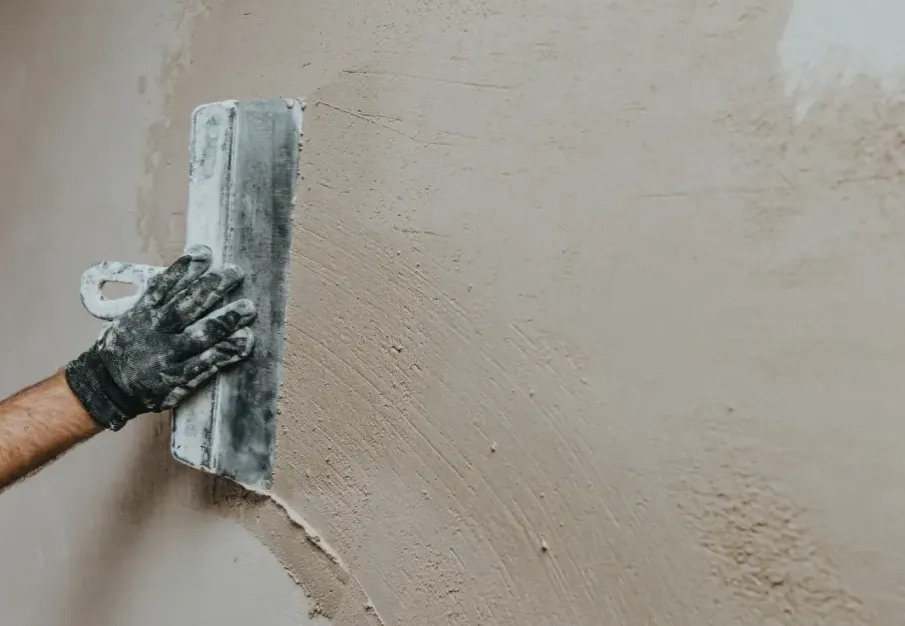 Patched and texture-matched stucco wall after impact damage repair