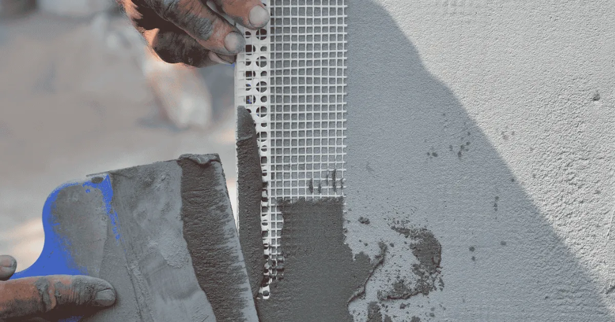 Stucco patch material being applied and texture-matched on an exterior wall