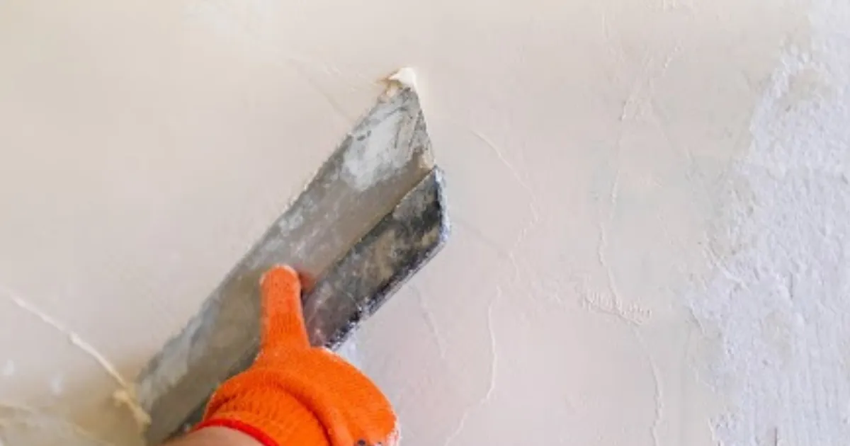 Repaired traditional lime stucco wall on an older home