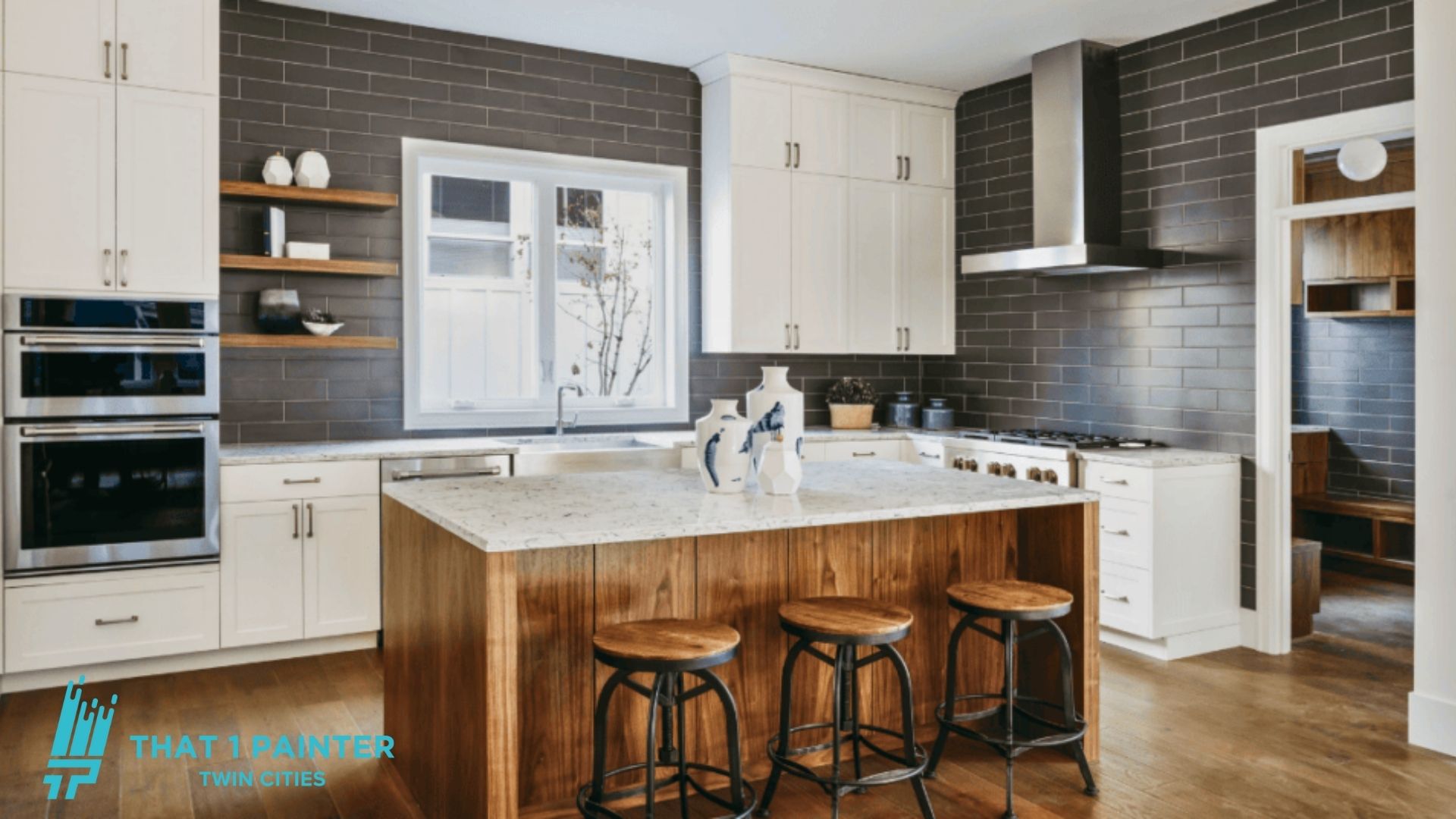 Kitchen with white painted cabinets and a dark tile backsplash in Minnetonka, MN