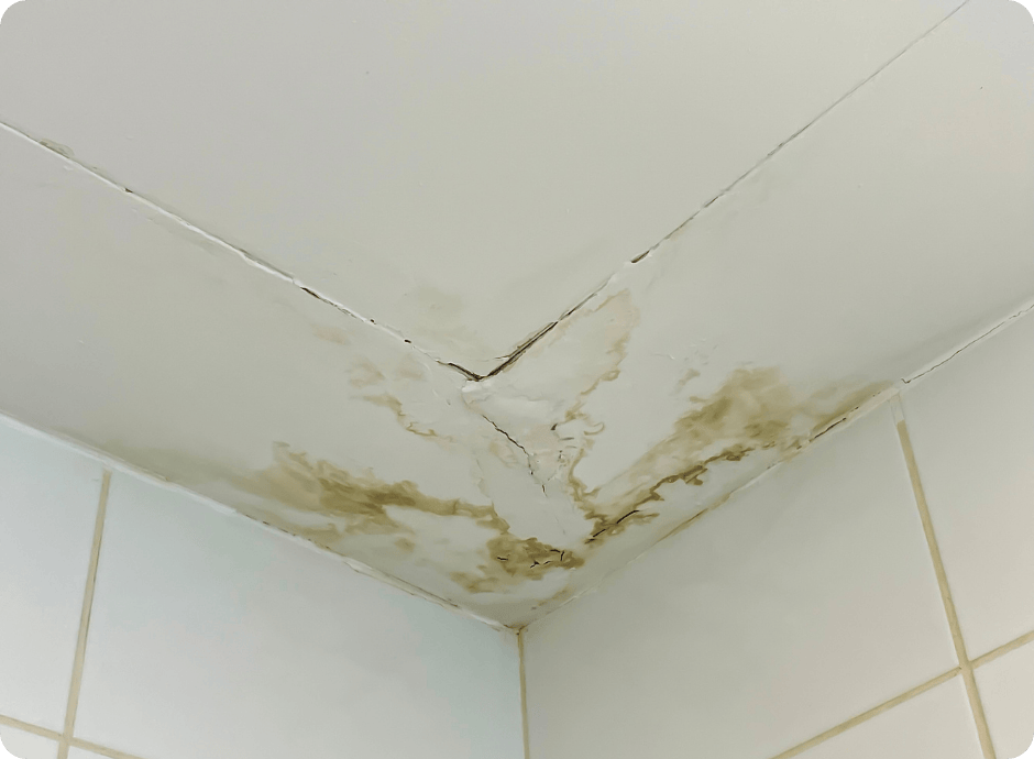 Bathroom ceiling corner with severe water damage and cracks calling for repair services with that 1 painter