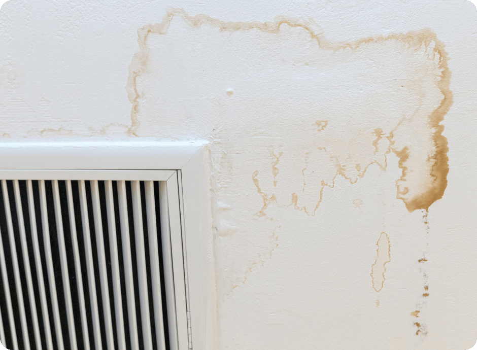Water-stained wall around an air vent requiring professional repair services with that 1 painter