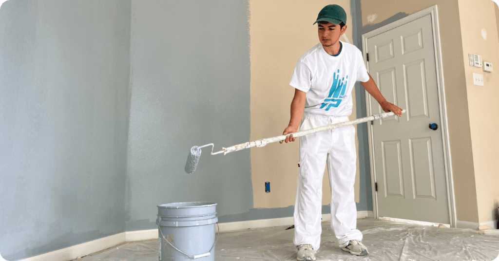interior painting in Bryan-College Station_ paint a bedroom wall light blie with a roller for that 1 painter