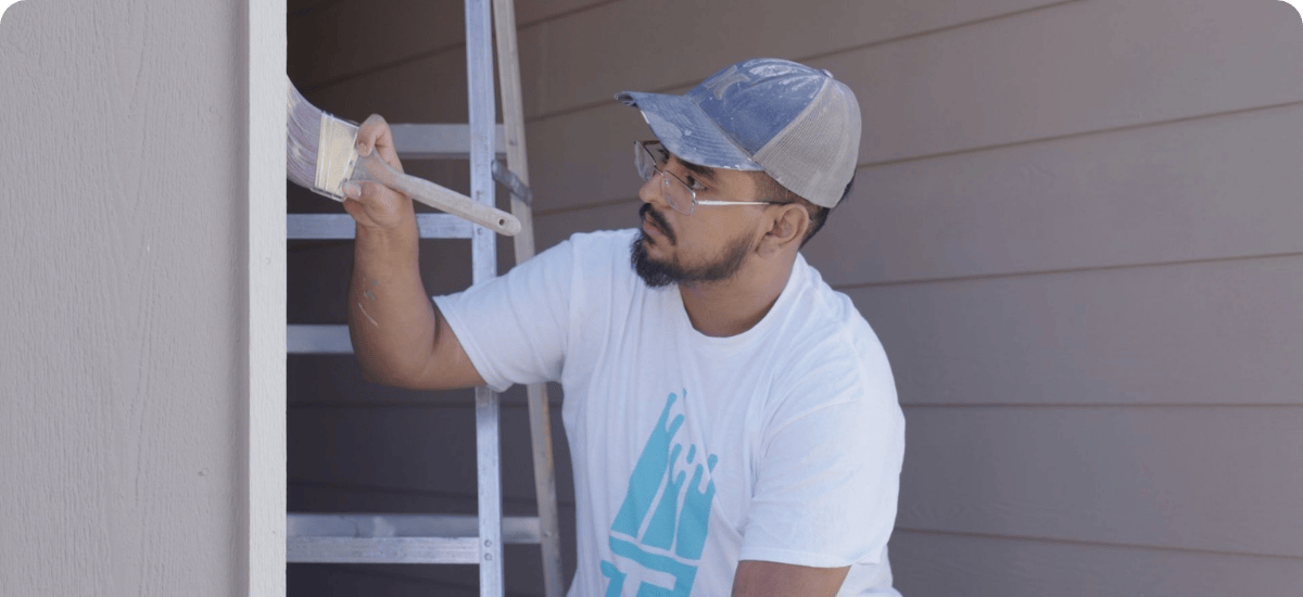 exterior painting being done by painter with white paint for that 1 painter canton