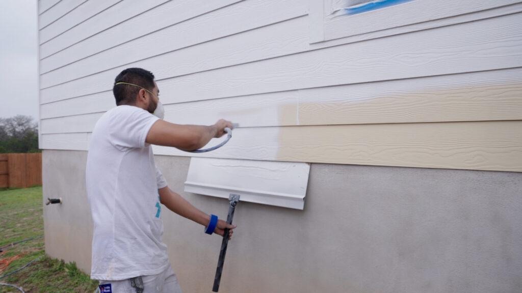 Professional Painting_Painter applying paint to house exterior_That 1 Painter Central PA