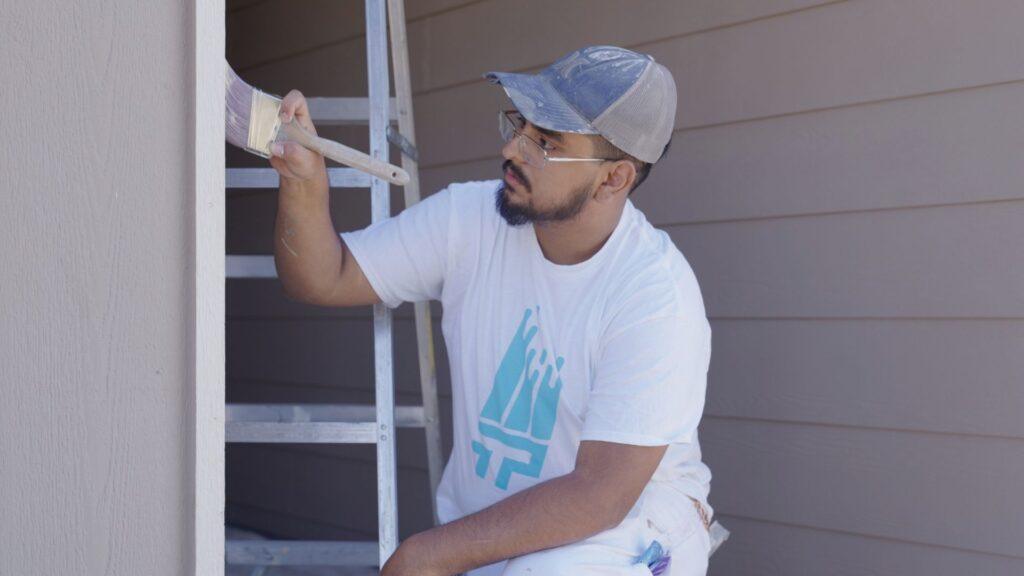 Professional Painting_Painter applying paint on trim with professional tools_That 1 Painter Central PA