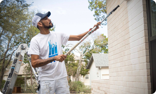 that1painter servicer painting side of exterior house