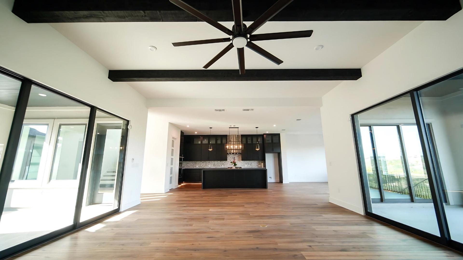 Professionally painted room with black painted kitchen in background