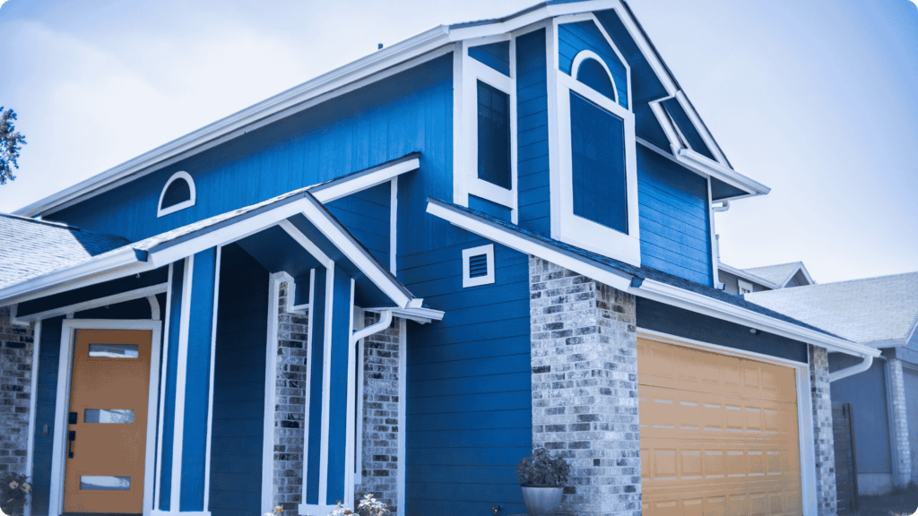 The exterior of a home painted blue by That 1 Painter East Austin Bastrop