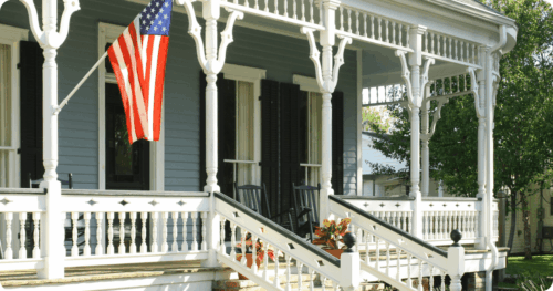 Front porch of a historic home painted light blue with white porch accents all painted by professional painters in Jacksonville.