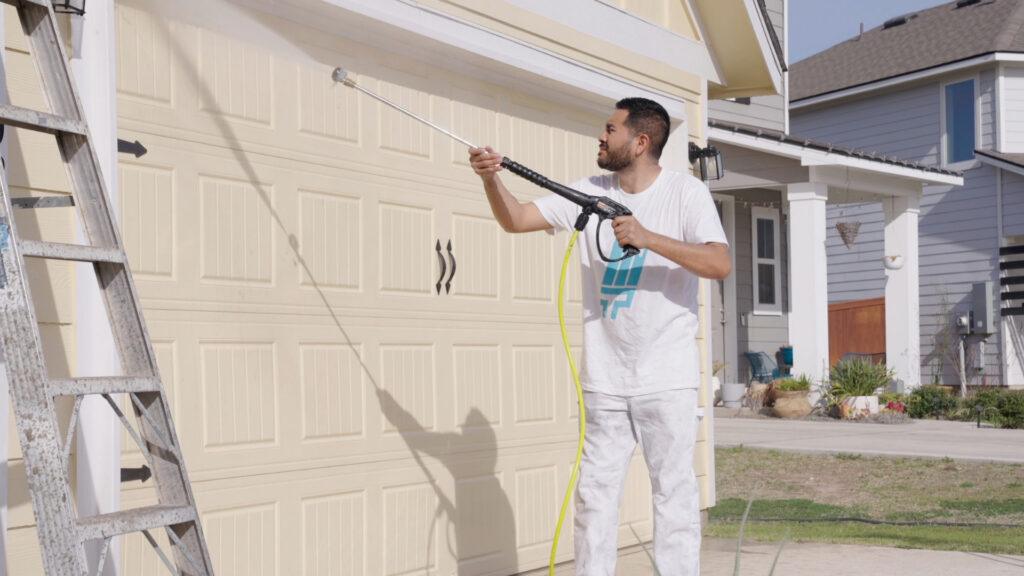 Pressure washing services being performed on a garage door in el paso texas_that 1 painter