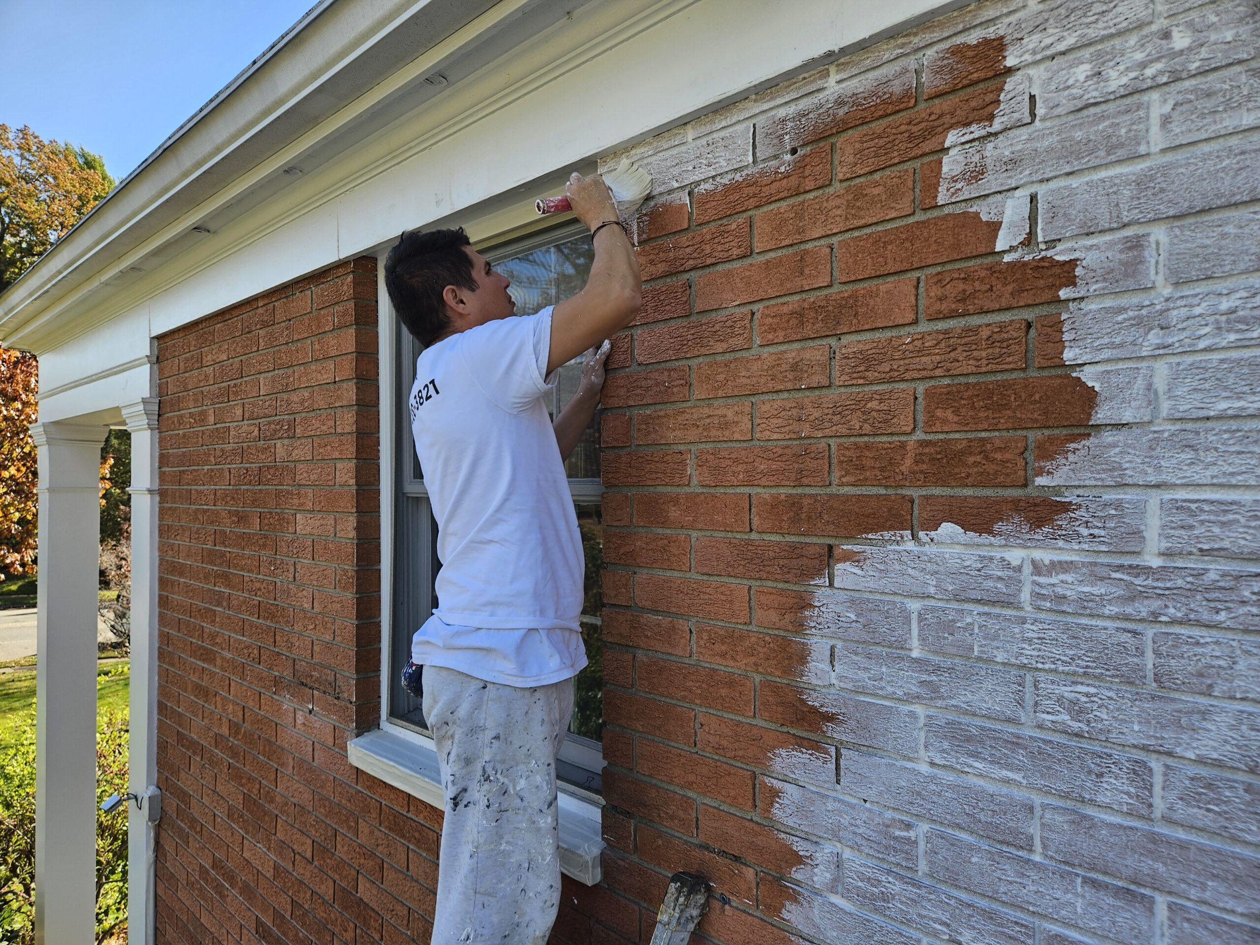 hire a professional painter painting a red brick wall with white paint That 1 Painter_Essex