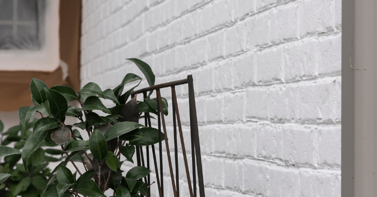 Close up of a brick house wall that was recently painted white using masonry paints_That 1 Painter Fairax McLean