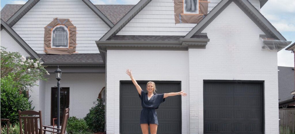 woman standing in front of her home that was recently painted using romabio limewash_That 1 Painter Fairfax Mclean