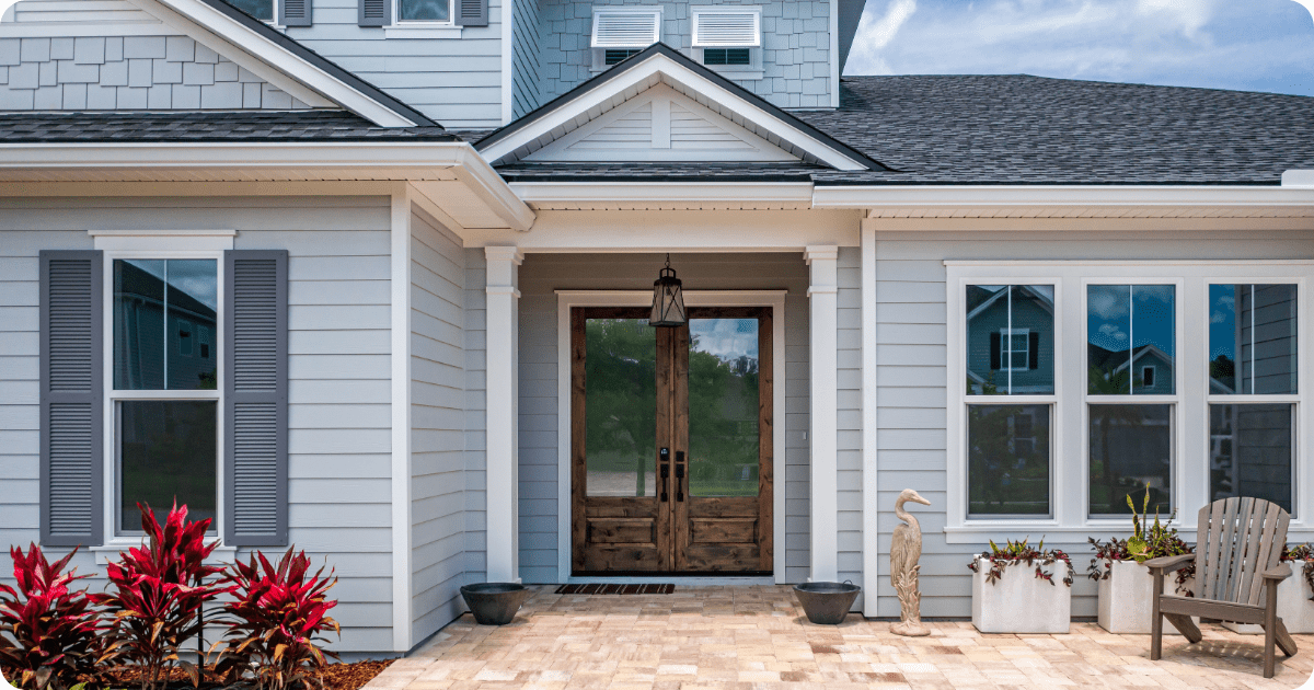 exterior painting in first coast-light blue home with white trim and grey roof painted by that 1 painter