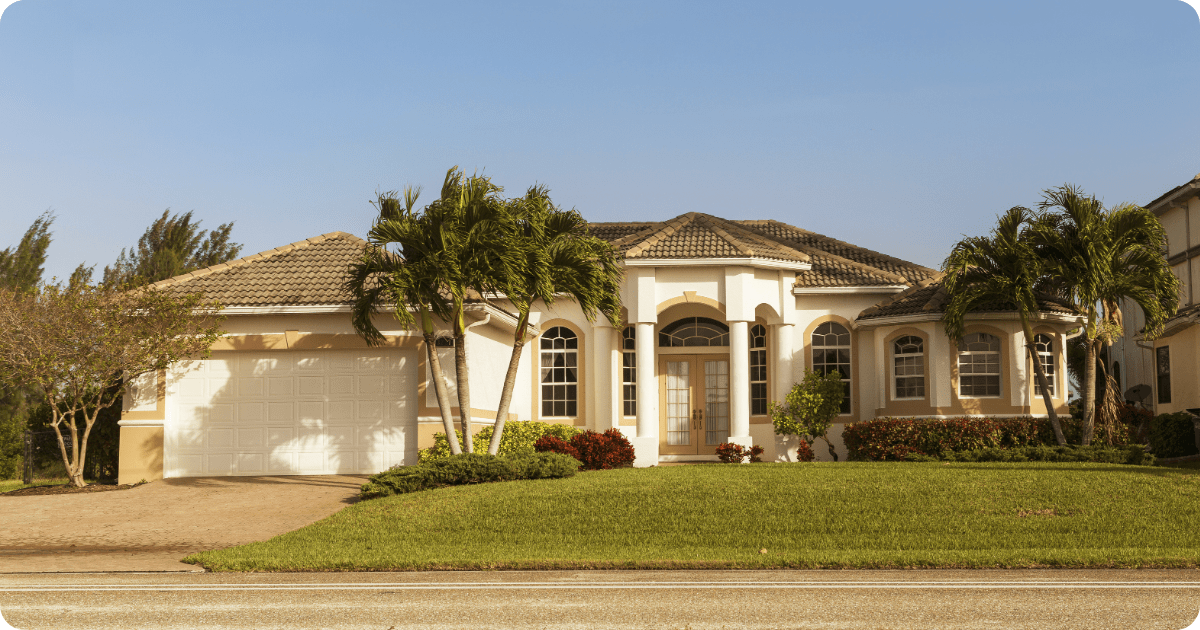 exterior painting in first coast-white home with dark brown roof painted by that 1 painter