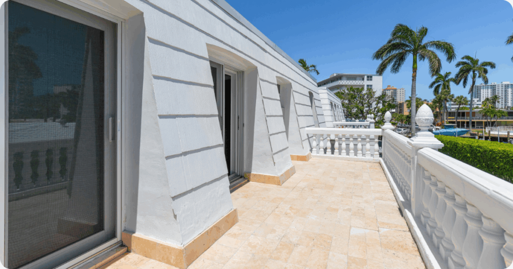 exterior painting in fort lauderdale-light blue siding and white fence painted by that 1 painter