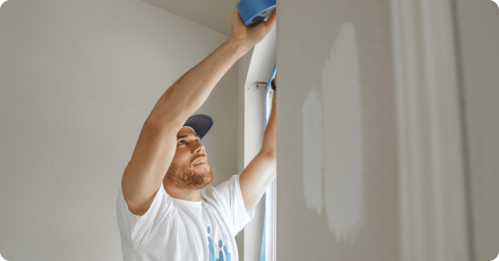 painters in brookline start the set up of painting with blue tape on the interior walls for that 1 painter