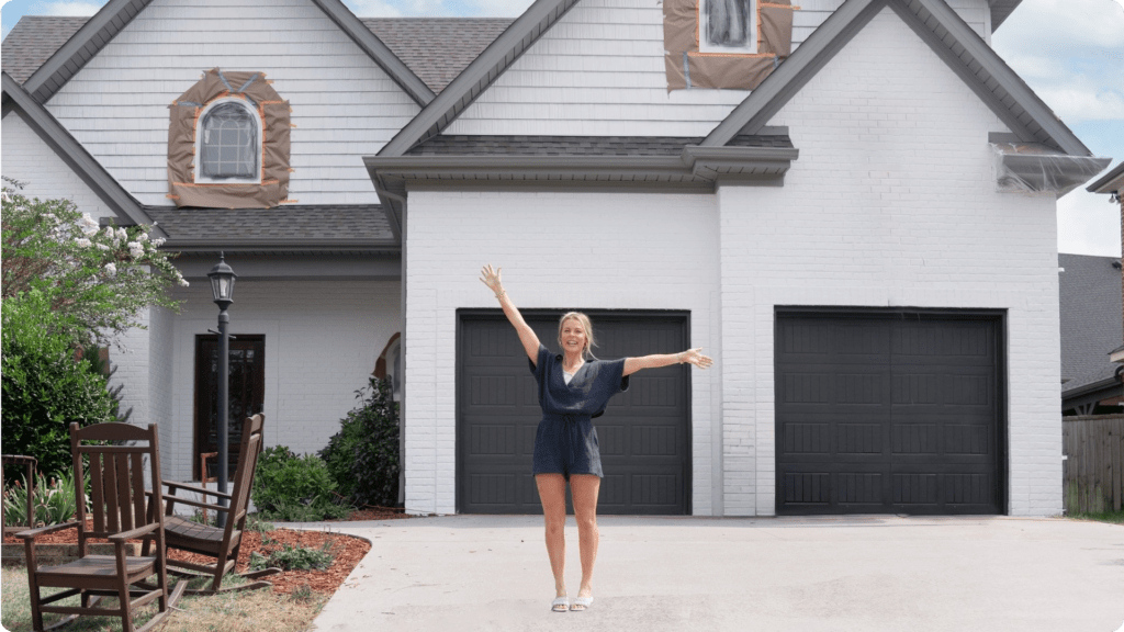 That 1 Painter Houston used their limewash services to help satisfy a client who is standing in front of her house with excitement.